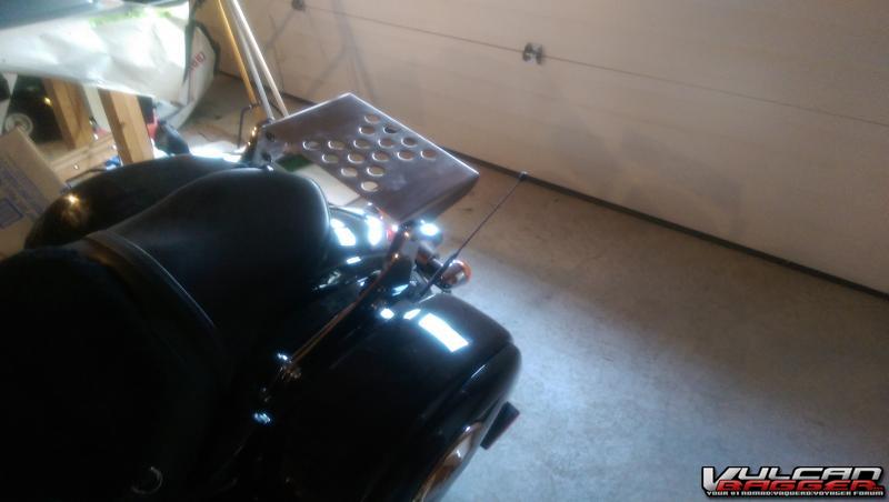 Flat stainless steel luggage rack made by a buddy and bolted to the Kawasaki KQR system
